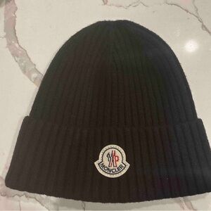 Moncler rib-knit virgin wool beanie featuring the brand's signature logo patch.